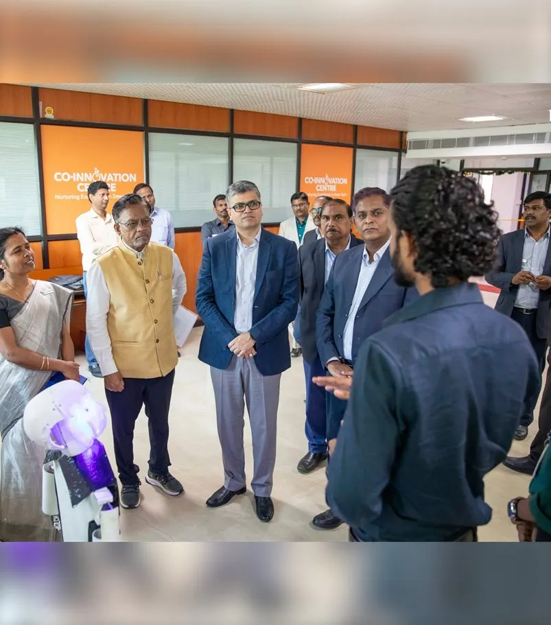 Guests and faculty watching a student robot demonstration at the Co-Innovation Centre, Karunya
