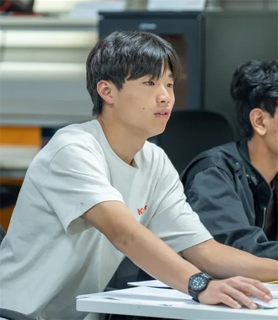 Two students working together on a design at a workstation