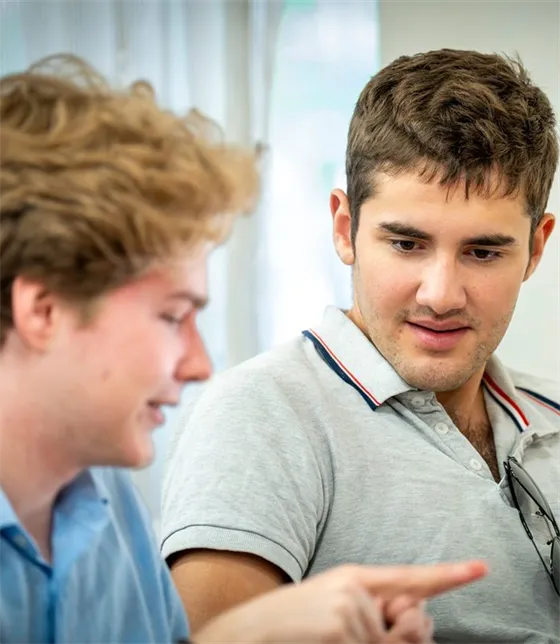 Two students discussing their research