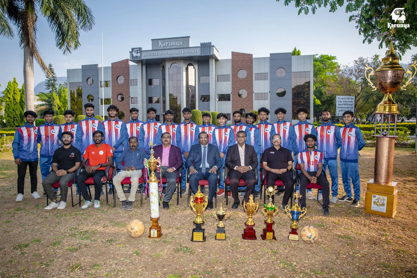 Karunya men's team with coaches and staff beside the season's trophies.