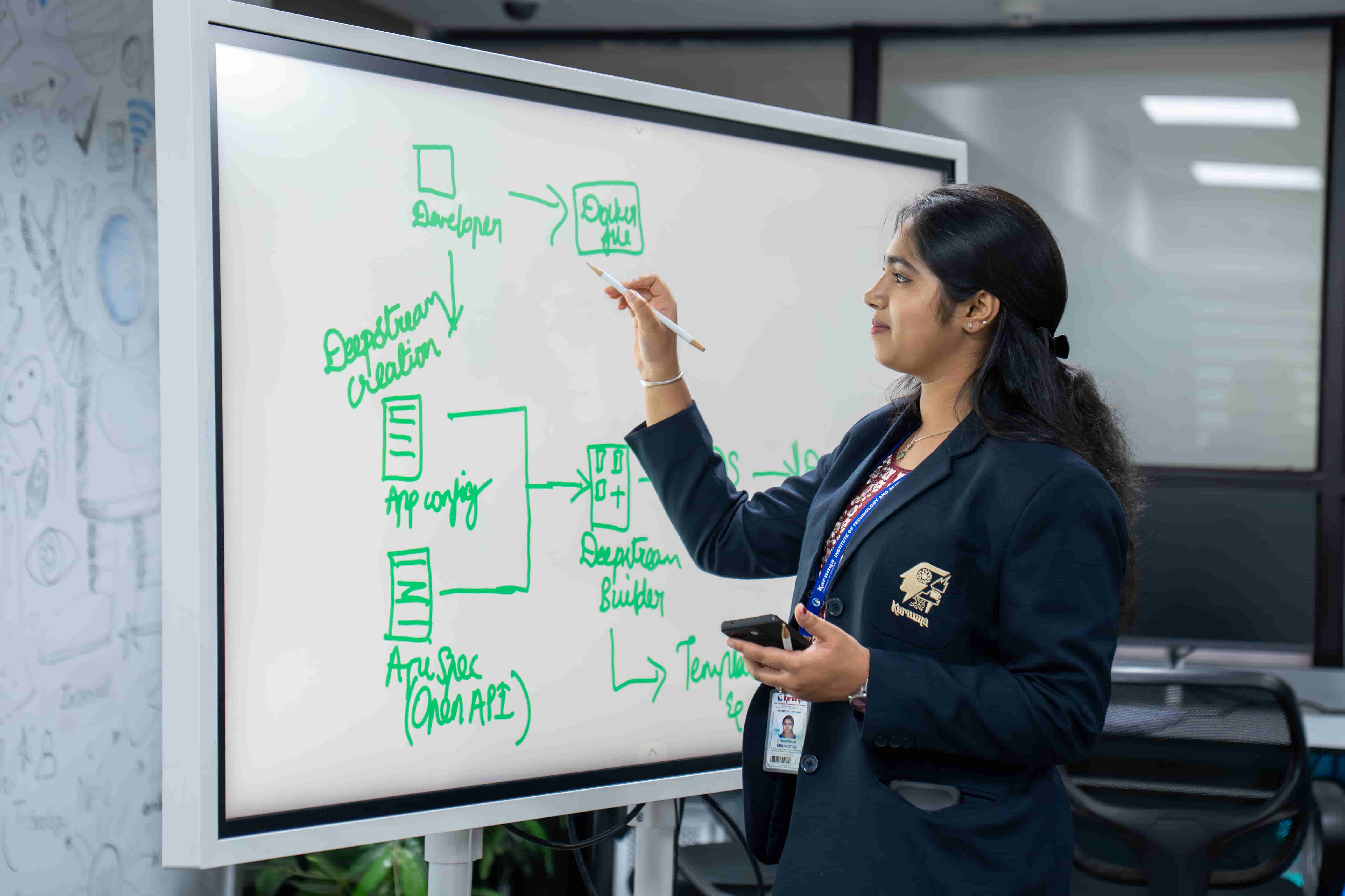 Student presenting AI architecture on smartboard